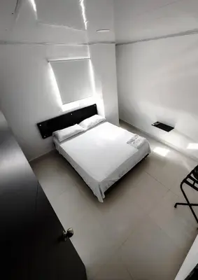 a bedroom with a white bed in a room at Hotel bazurto plaza in Cartagena de Indias