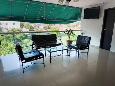 a room with a table and chairs and a large window at Hotel bazurto plaza in Cartagena de Indias