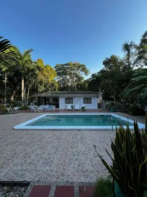 a swimming pool in front of a house at Casa finca Santiago Tolú in Altamira