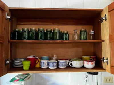 a cabinet filled with lots of cups and plates at Casa finca Santiago Tolú in Altamira