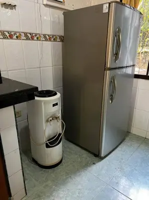 a kitchen with a stainless steel refrigerator and a trash can at Casa finca Santiago Tolú in Altamira