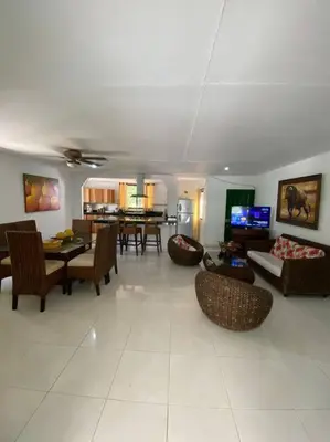 a living room with furniture and a dining room at Casa finca Santiago Tolú in Altamira
