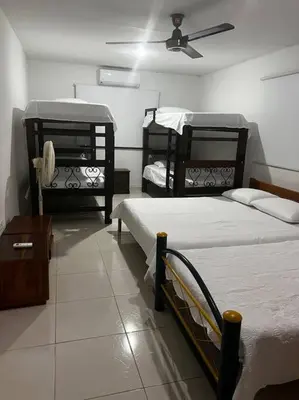 a bedroom with two beds and a ceiling fan at Casa finca Santiago Tolú in Altamira