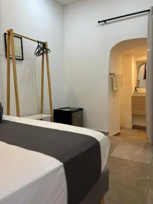 a bedroom with a bed and a room with a bathroom at Casa Zaguan in Cartagena de Indias