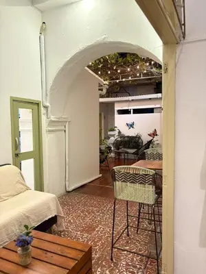 a living room with a table and chairs in a room at Casa Zaguan in Cartagena de Indias
