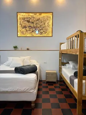 two bunk beds in a room with a checkered floor at Casa Zaguan in Cartagena de Indias