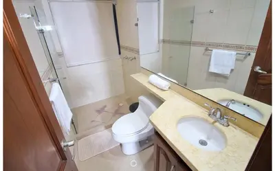 a bathroom with a sink and a toilet and a mirror at Torres del lago de 3 habitaciones in Cartagena de Indias