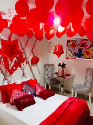 a bedroom with red balloons hanging above a bed at Hotel Platinum Luxury in Barranquilla