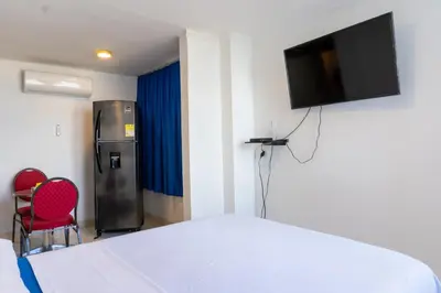 a bedroom with a bed and a television on a wall at Acogedor Apartaestudio Laguito 1 Habitacion N4A1 in Cartagena de Indias