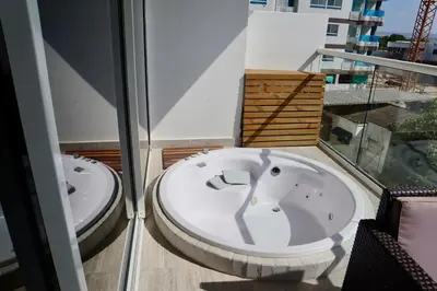 two jacuzzi tubs sitting on top of a balcony at Dominique in Cartagena de Indias