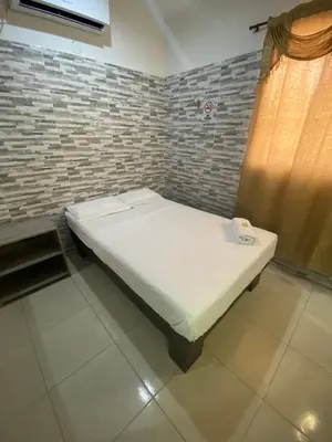 a small bed in a room with a window at Hotel Rancho Grande in Barranquilla