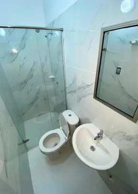 a bathroom with a toilet and a sink and a shower at Hotel Rancho Grande in Barranquilla