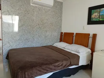 a bed in a room with a wall at Hotel Palma Real Cartagena in Cartagena de Indias
