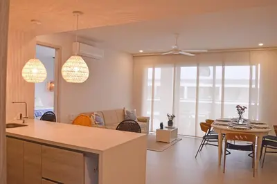 a kitchen and living room with a table and chairs at Lujoso Penthouse - Vista al Mar - Playa Privada in Cartagena de Indias