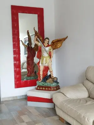 a statue of an angel sitting in a living room at HOTEL BELLAMAR in Cartagena de Indias