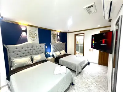 a hotel room with two beds and a flat screen tv at Casa de Lujo en Condominio Privado por habitaciones in Cartagena de Indias
