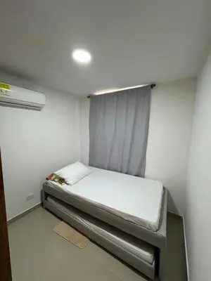 a small bedroom with a bed in a room at Apto amoblado en Alameda del Río in Barranquilla