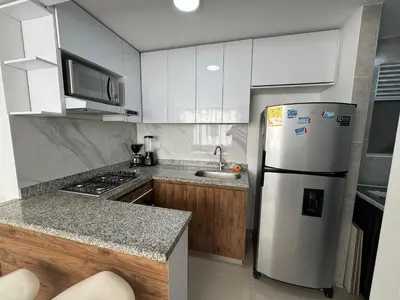 a kitchen with a refrigerator and a sink at Apto amoblado en Alameda del Río in Barranquilla