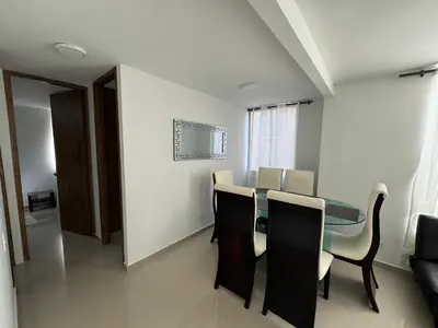 a dining room with a glass table and chairs at Apto amoblado en Alameda del Río in Barranquilla