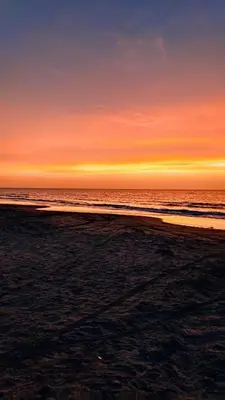 a sunset on the beach with the ocean at Sharick Beach House in Tubará
