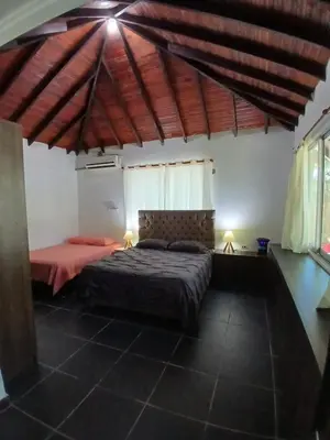 a bedroom with a bed in a room at Sharick Beach House in Tubará