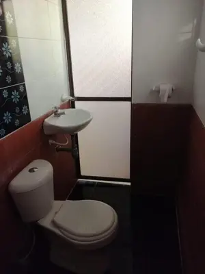 a small bathroom with a toilet and a sink at Cabaña Moñitos cerca al mar e Isla Fuerte in Moñitos
