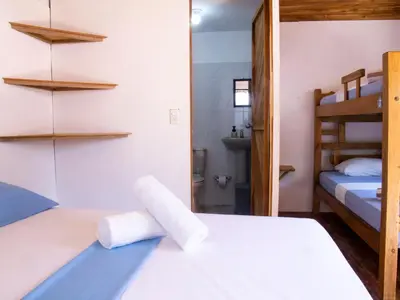 a bedroom with two bunk beds and a bathroom at Mithival Beach Rincón del Mar in Rincón