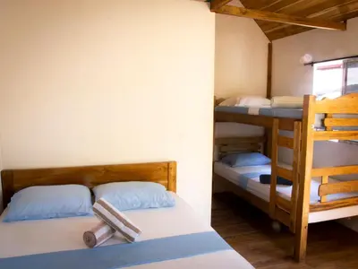 a room with two bunk beds and a ladder at Mithival Beach Rincón del Mar in Rincón