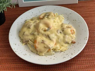 a plate of pasta with shrimp and mushroom sauce at Hotel Boutique Chateau de la Mar in Juan de Acosta