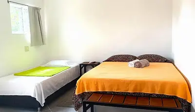 a room with two beds in a room at Hotel Boutique Chateau de la Mar in Juan de Acosta