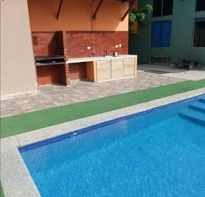 a swimming pool next to a building with a sink at Espectacular Cabaña en Santa Veronica in Santa Veronica