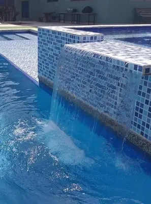 a swimming pool with a fountain in the water at Espectacular Cabaña en Santa Veronica in Santa Veronica