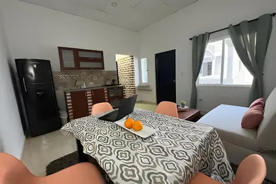 a room with a table with a laptop on it at Céntrico y confortable apto casa Doña yola 5 in Cartagena de Indias