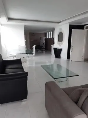 a living room with a couch and a glass table at 360° Sea View Penthouse 17° floor, Cartagena in Cartagena de Indias