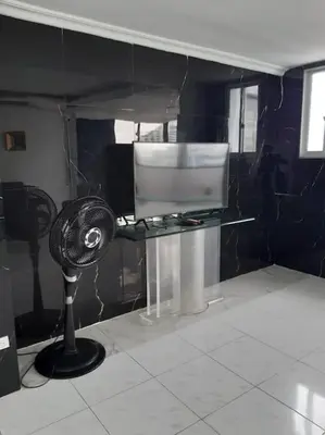 a black and white room with a fan and a table at 360° Sea View Penthouse 17° floor, Cartagena in Cartagena de Indias