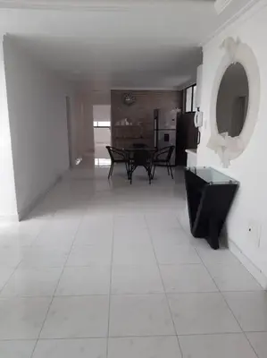 a living room with a table and a white tile floor at 360° Sea View Penthouse 17° floor, Cartagena in Cartagena de Indias