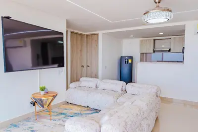 a living room with a couch and a tv at U-GO Ocean Drive: Apto Moderno con Balcón y Mar in Cartagena de Indias
