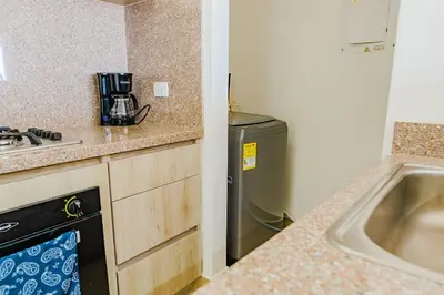a small kitchen with a sink and a dishwasher at U-GO Ocean Drive: Apto Moderno con Balcón y Mar in Cartagena de Indias