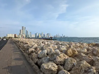 a rock wall next to the ocean with a city at U-GO Ocean Drive: Apto Moderno con Balcón y Mar in Cartagena de Indias