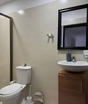 a bathroom with a toilet and a sink and a mirror at Céntrico y confortable apto Casa Doña yola 7 in Cartagena de Indias