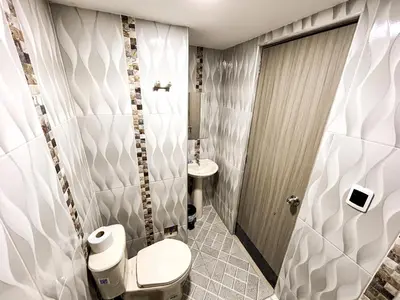 a bathroom with a toilet and a sink at Hotel & Restaurante Oasis CTG in Cartagena de Indias