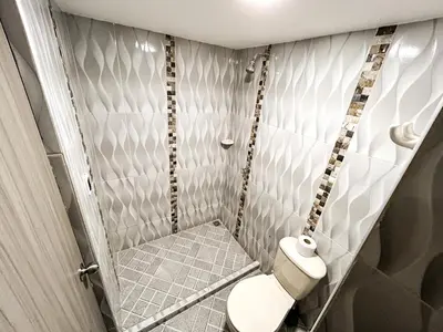 a small bathroom with a toilet in a room at Hotel & Restaurante Oasis CTG in Cartagena de Indias