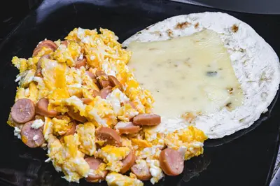 a tortilla with hot dogs and cheese on it at Hotel & Restaurante Oasis CTG in Cartagena de Indias