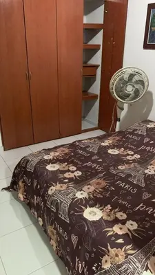 a bedroom with a bed with a black and white blanket at Habitacion Medusa in Barranquilla