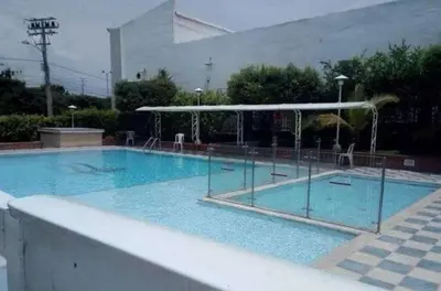 a large blue swimming pool with a canopy at Habitacion Medusa in Barranquilla