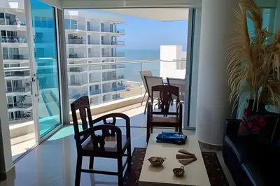 a room with three chairs and a table and a large window at Apartamento 2 Dormitorios Morros. Vista Mar in Cartagena de Indias