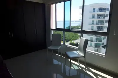 two chairs in a room with a large window at Apartamento 2 Dormitorios Morros. Vista Mar in Cartagena de Indias