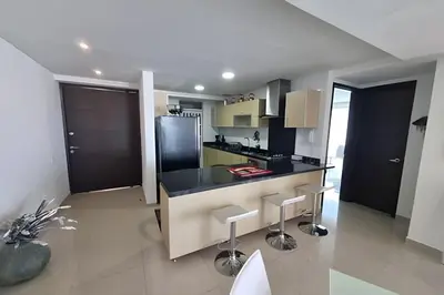 a kitchen with a black counter and stools at Apartamento 2 Dormitorios Morros. Vista Mar in Cartagena de Indias