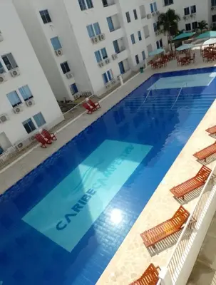 a large swimming pool in front of a building at Apartamento de descanso Om Shanti Om in Coveñas