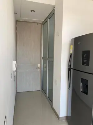 a hallway with a refrigerator in a room at Apartaestudio Jacuzzi Centro Comercial Gimnasio ALTOPRADO in Barranquilla